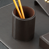 brown leather pencil cup with white stitched trim