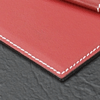 corner detail of red leather desk pad blotter